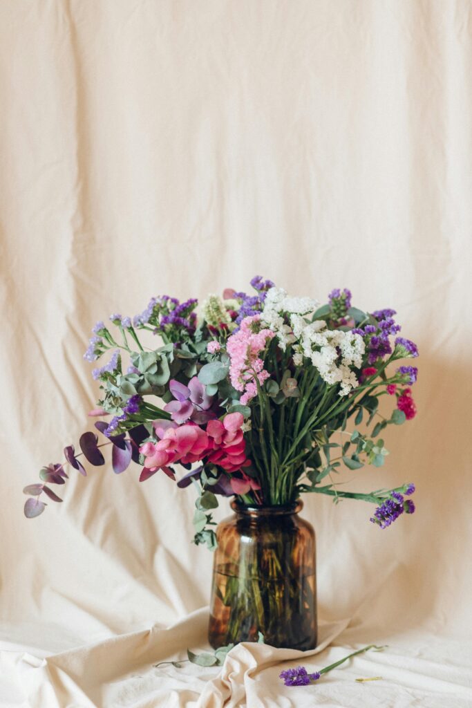 A picture of a vase with colorful flowers. 