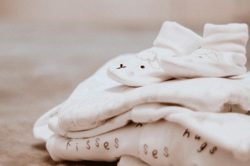 A picture of a stack of baby clothes. 